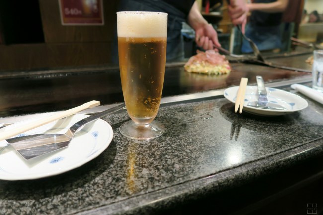 Osaka Japan. Mizuno - Having beer waiting for Okonomiyaki