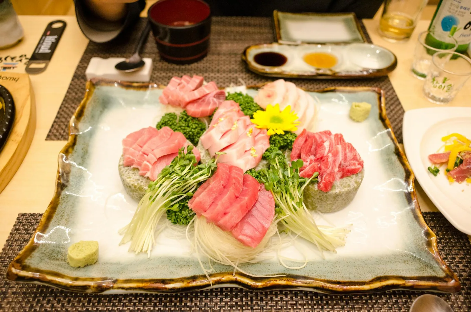 Vibrant sashimi selection with garnishes on a decorative plate, capturing the essence of Japanese cuisine.